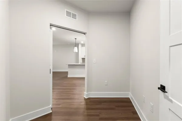 a view of a hallway with wooden floor