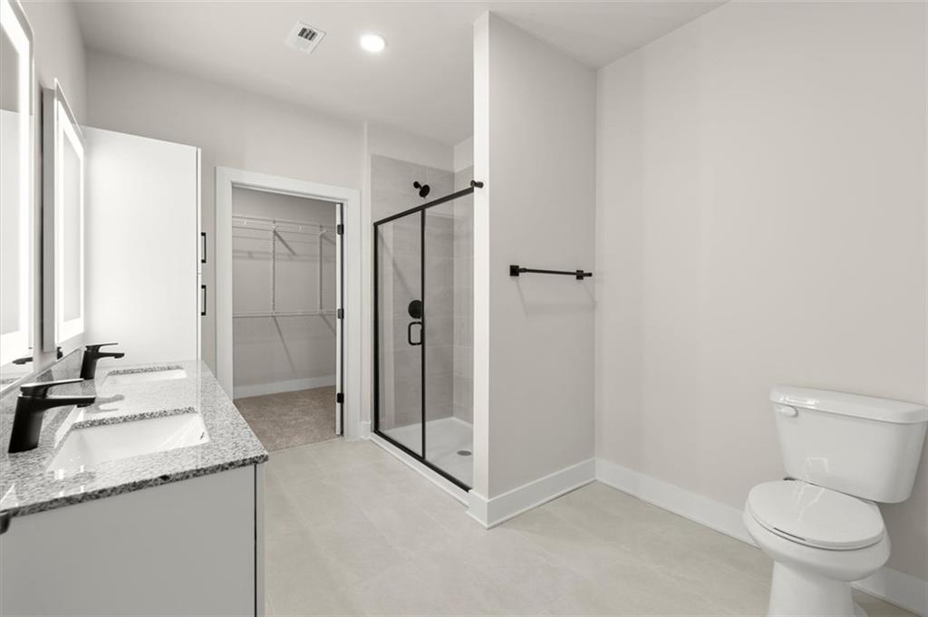 2648 Sandy Plains Road, Unit 137 Marietta, GA 30062 - Photo 19 of 38 a bathroom with a granite countertop sink toilet and shower