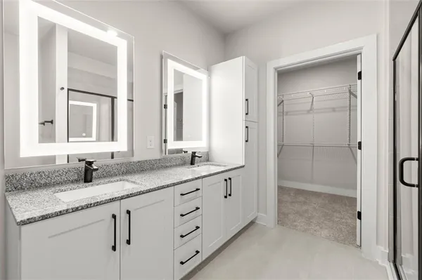 a bathroom with a granite countertop sink mirror and double