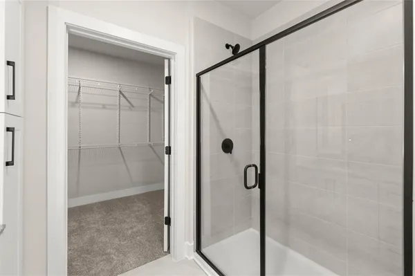 a bathroom with a glass shower door