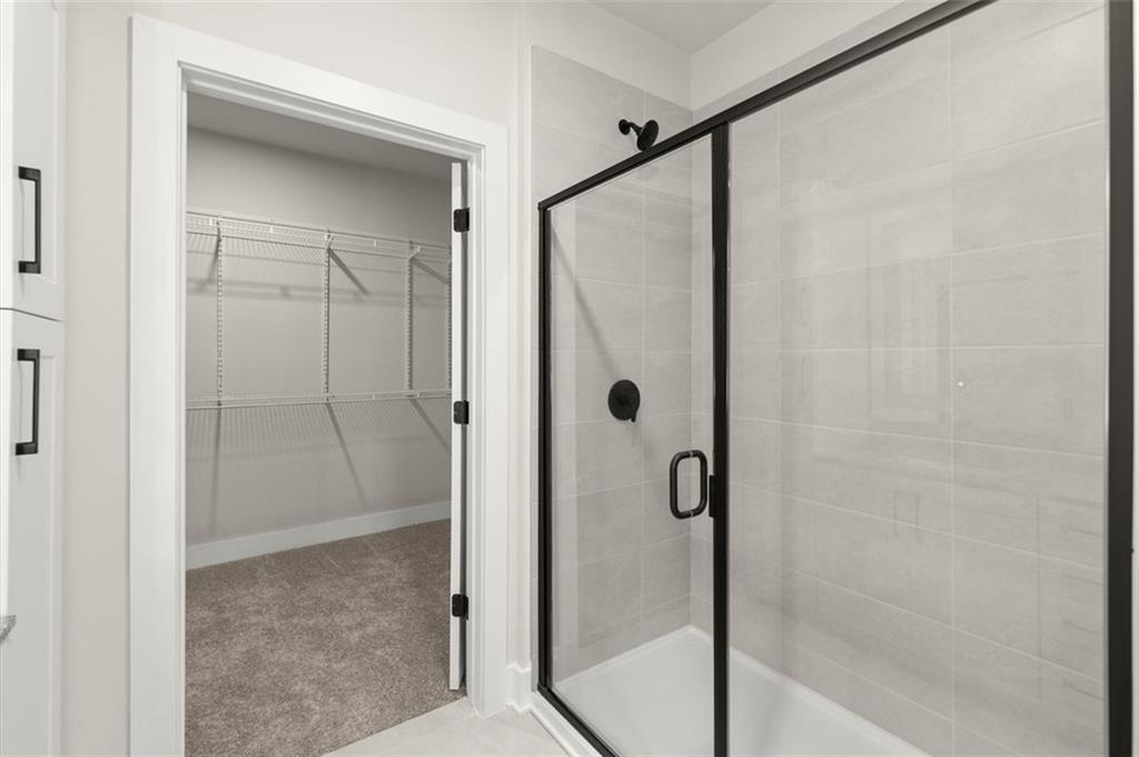 2648 Sandy Plains Road, Unit 137 Marietta, GA 30062 - Photo 21 of 38 a bathroom with a glass shower door