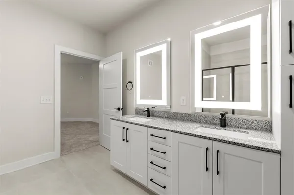 a bathroom with double sink and a mirror