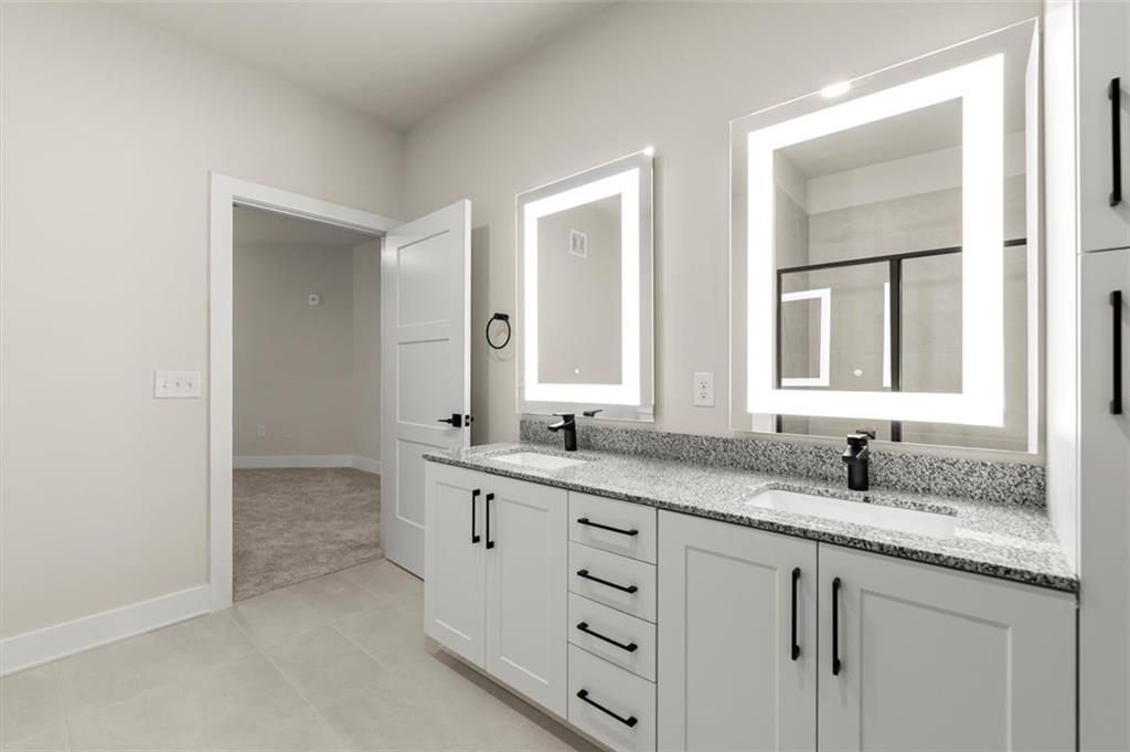 2648 Sandy Plains Road, Unit 137 Marietta, GA 30062 - Photo 24 of 38 a bathroom with double sink and a mirror