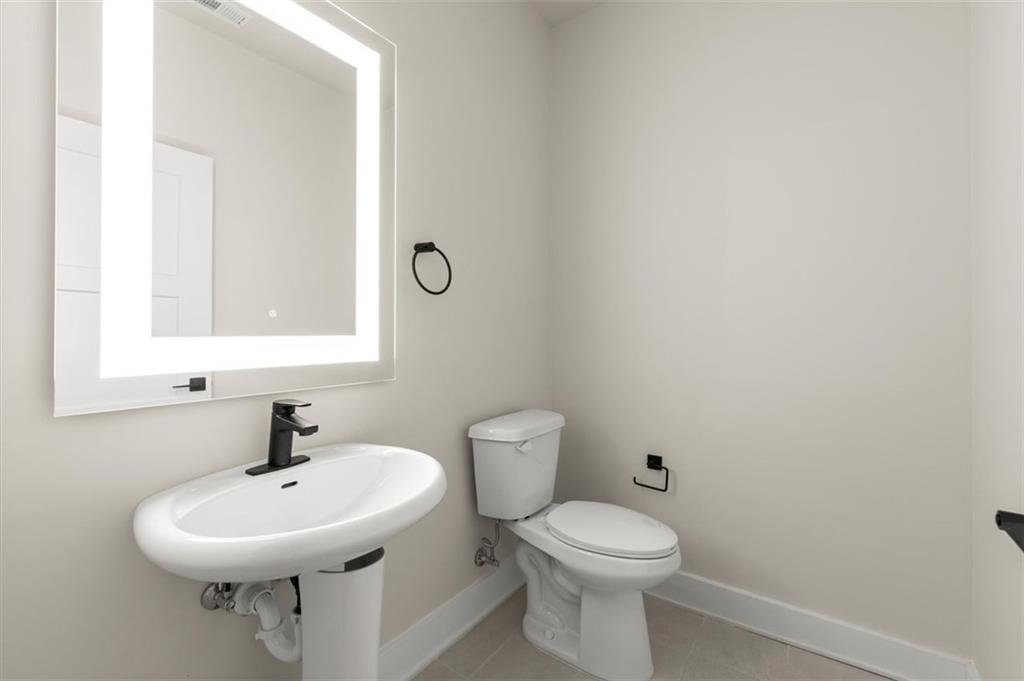 2648 Sandy Plains Road, Unit 137 Marietta, GA 30062 - Photo 25 of 38 a bathroom with a toilet sink and mirror