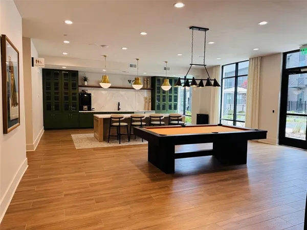 a kitchen with stainless steel appliances granite countertop a stove and a view of living room