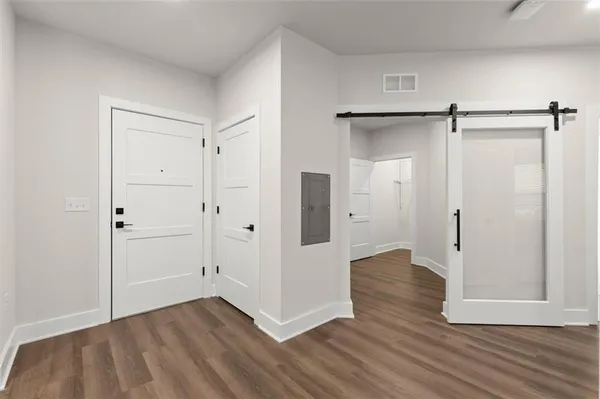 a view of empty room with wooden floor