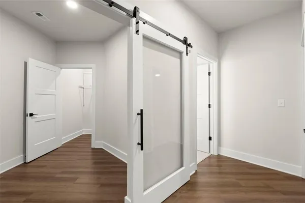 a view of hallway with wooden floor