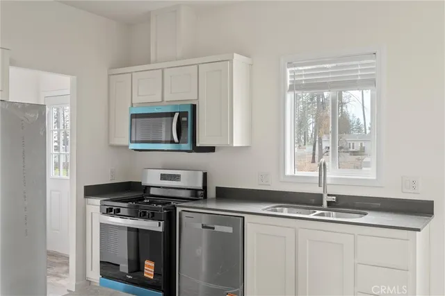 a bathroom with a granite countertop sink and a toilet