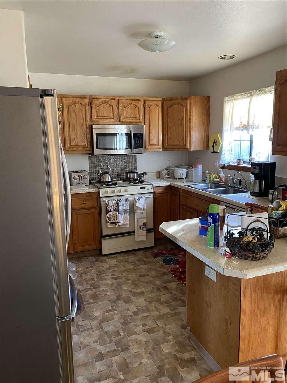 370 Lewis Lane Fallon, NV 89406 - Photo 4 of 11 a kitchen with stainless steel appliances granite countertop a sink stove and refrigerator