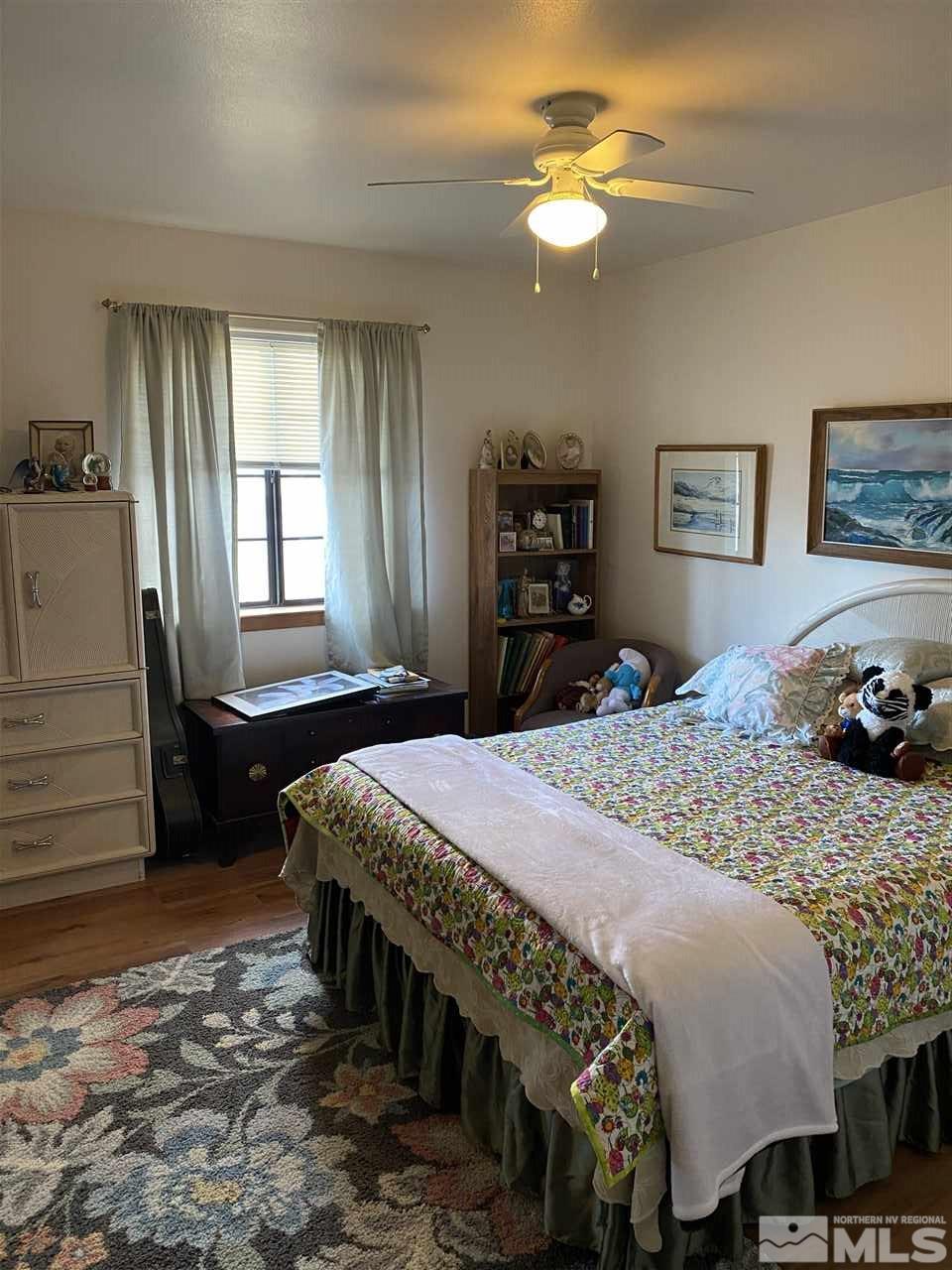 370 Lewis Lane Fallon, NV 89406 - Photo 5 of 11 a bedroom with a bed and a chandelier