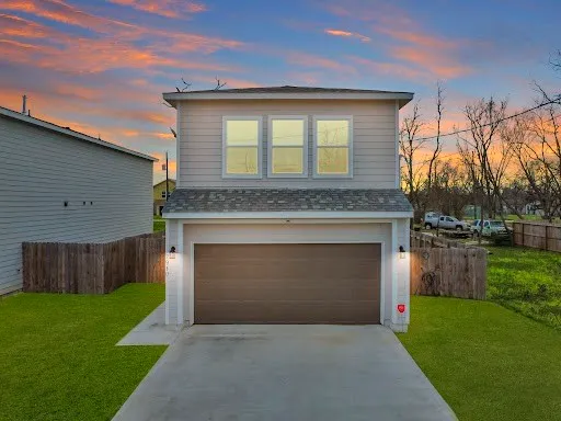 a front view of a house with a garden and yard