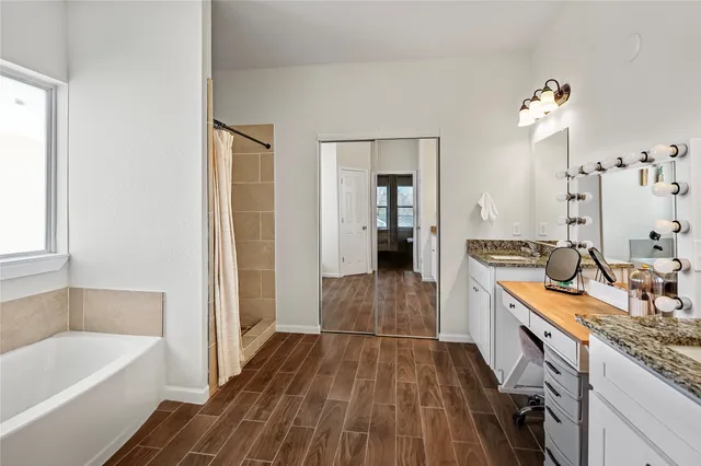 a bathroom with a bathtub a sink and a shower