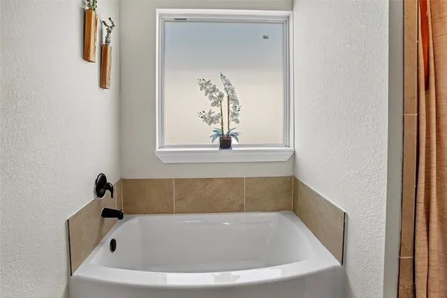 a white bath tub sitting in a bathroom