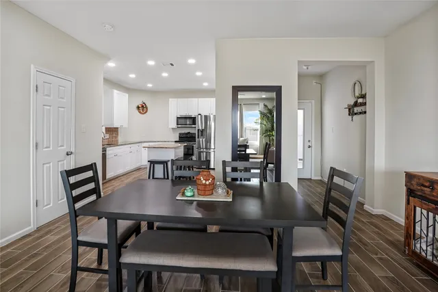 a view of a dining room with furniture and wooden floor