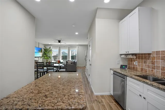 a kitchen with sink refrigerator and stove