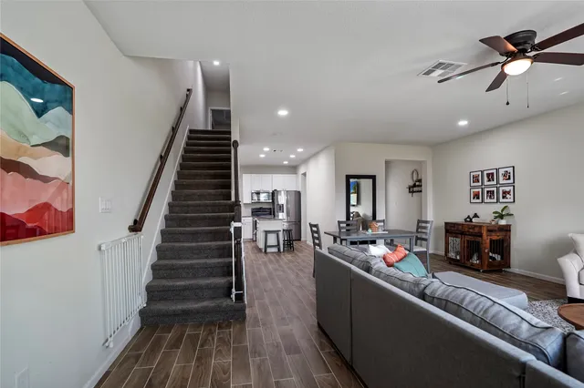 a living room with furniture and wooden floor