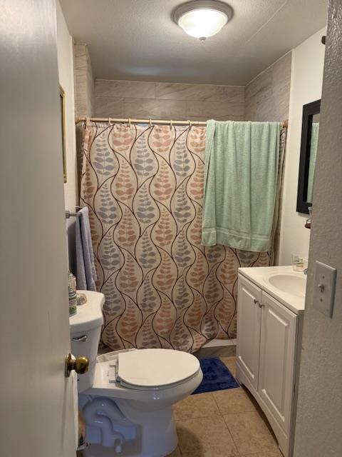 3219 East Huntsman Avenue, Unit 2 Fresno, CA 93725 - Photo 11 of 26 a white toilet sitting next to a shower curtain