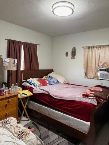 a bedroom that has a bed and a table in it