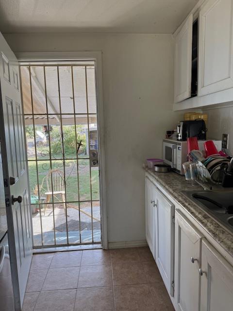 3219 East Huntsman Avenue, Unit 2 Fresno, CA 93725 - Photo 16 of 26 a kitchen with stainless steel appliances granite countertop a refrigerator a sink and white cabinets