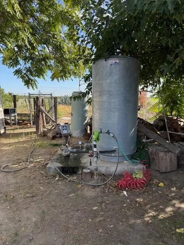 a view of a backyard with plants and a patio