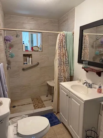 a bathroom with a sink toilet and shower
