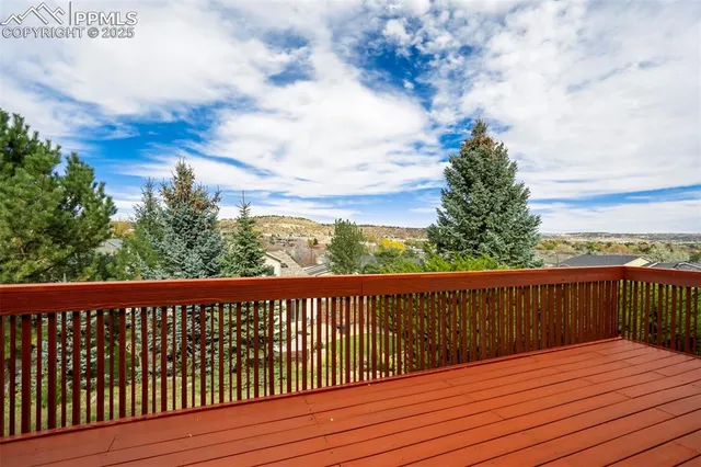 a view of a balcony with wooden fence