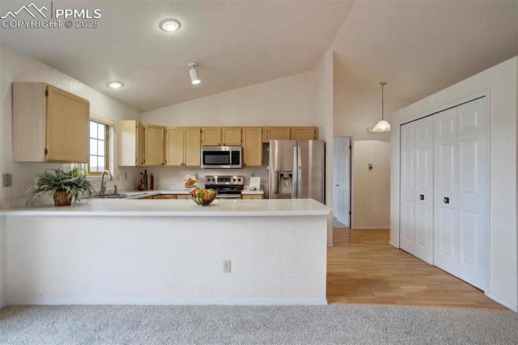 1528 Shane Circle Colorado Springs, CO 80907 - Photo 13 of 39 a kitchen with stainless steel appliances a sink a stove a refrigerator cabinets and a counter top space