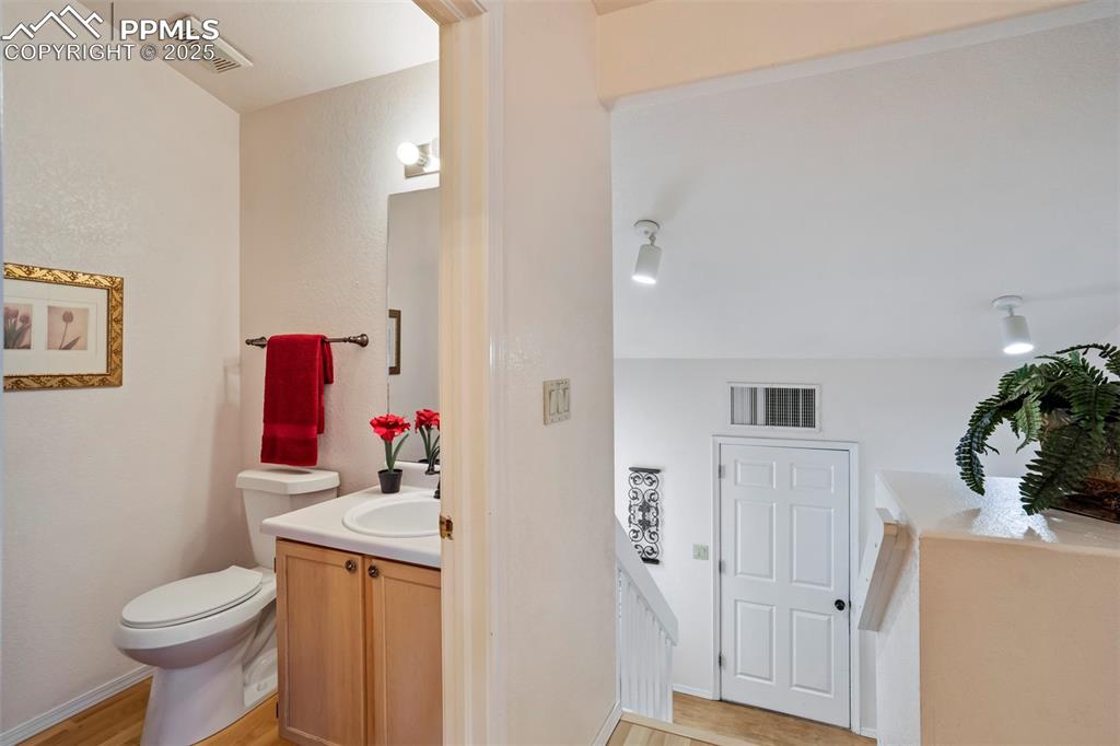 1528 Shane Circle Colorado Springs, CO 80907 - Photo 16 of 39 a bathroom with a sink toilet and vanity