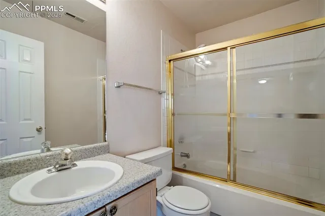 a house with green field in front of it