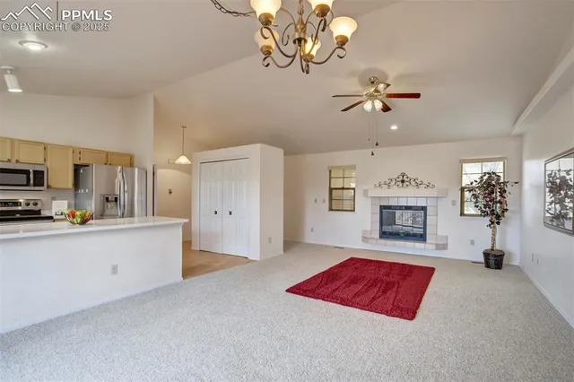 a view of kitchen with refrigerator and window