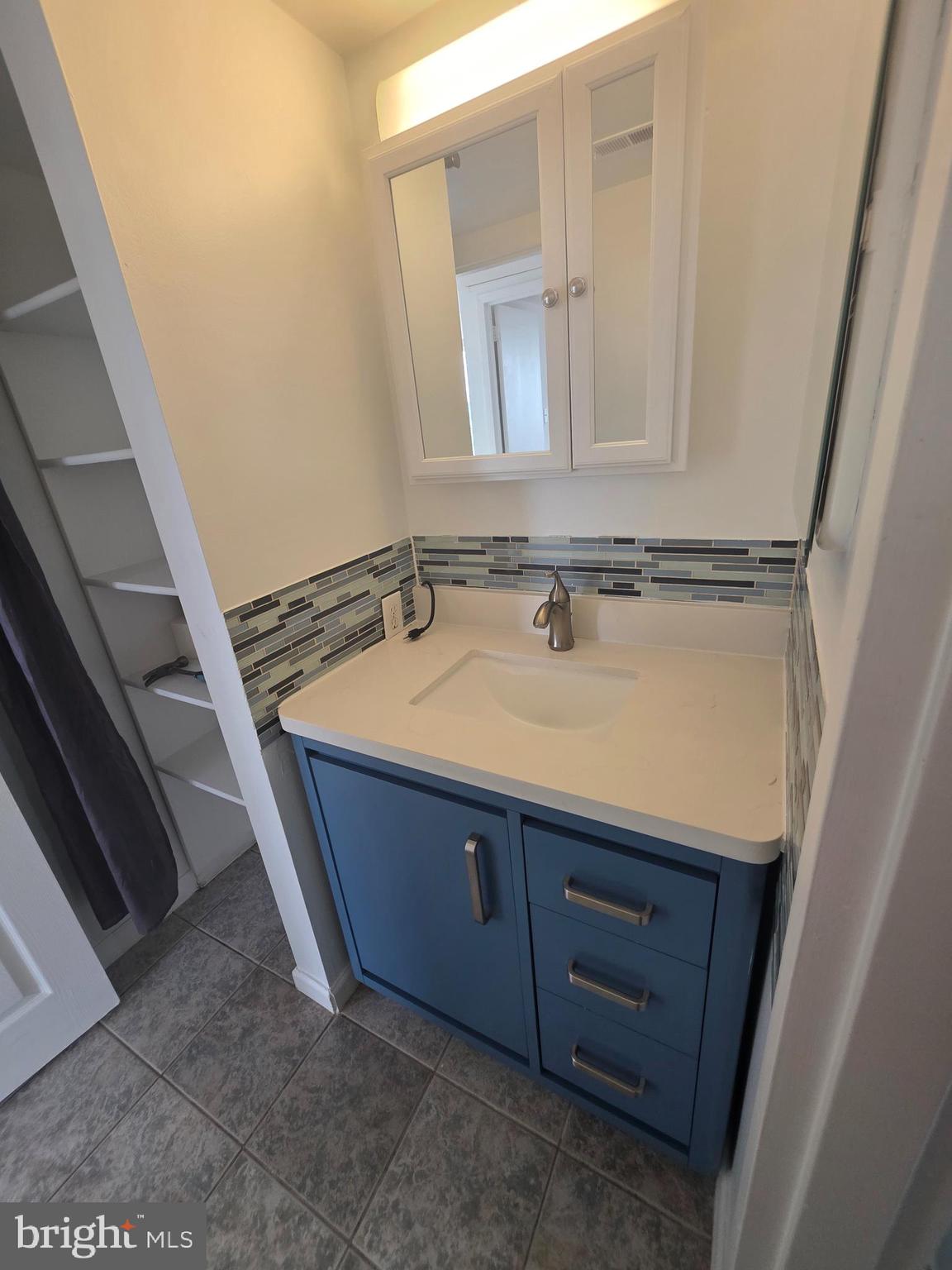1836 Metzerott Road, Unit 1704 Adelphi, MD 20783 - Photo 39 of 47 a bathroom with a sink and a mirror