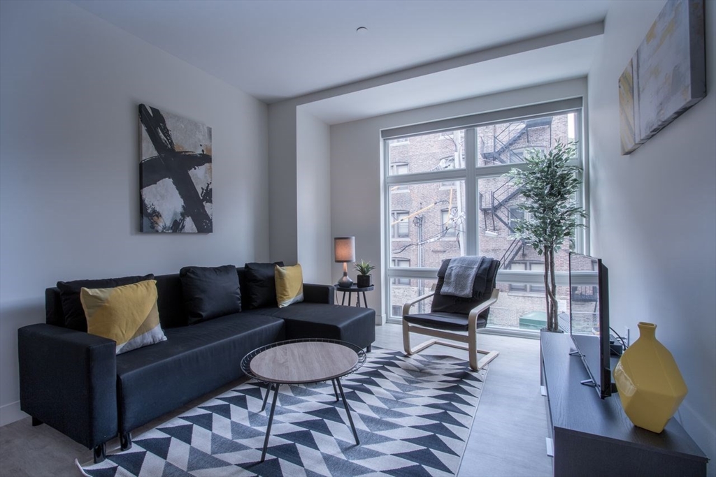a living room with furniture and a window