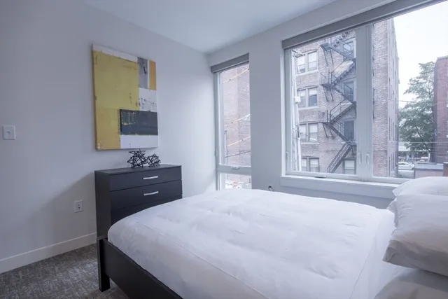 a bedroom with a bed and a window