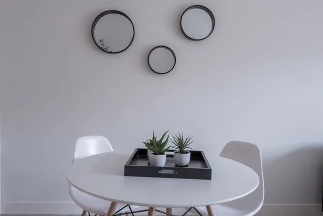 a table with a potted plant and a wooden floor