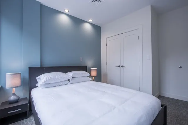 a bedroom with a bed and a night stand