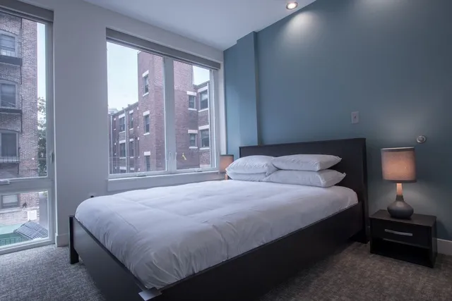 a bedroom with a bed and a lamp