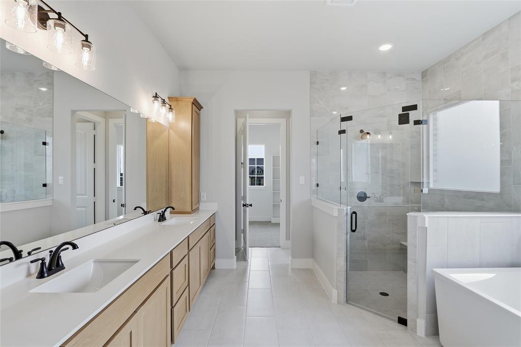 812 Vly Rdg Road Van Alstyne, TX 75495 - Photo 15 of 33 a bathroom with a double vanity sink mirror double shower and tub