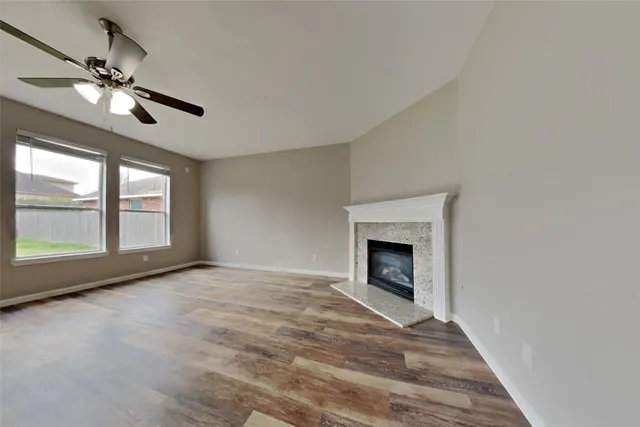 a view of empty room with window and fireplace