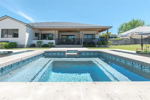 a view of a swimming pool with a patio