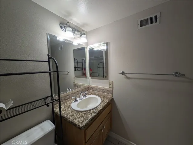 a bathroom with a sink granite and shower