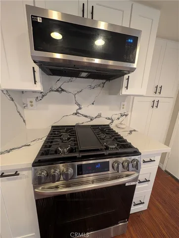 a stove sitting inside of a kitchen with granite countertop