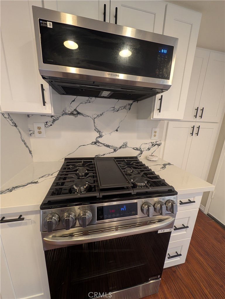 1197 Monte Sereno Drive Thousand Oaks, CA 91360 - Photo 6 of 27 a stove sitting inside of a kitchen with granite countertop