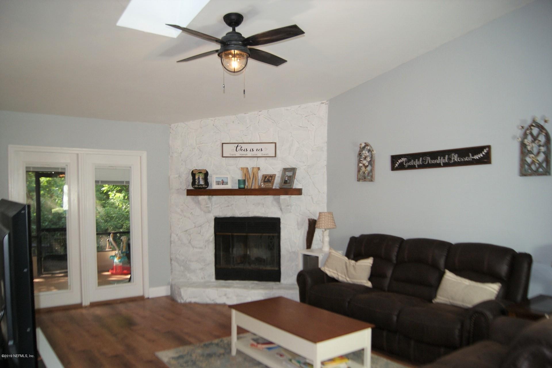 510 Jasmine Road St. Augustine, FL 32086 - Photo 2 of 14 a living room with furniture and a fireplace
