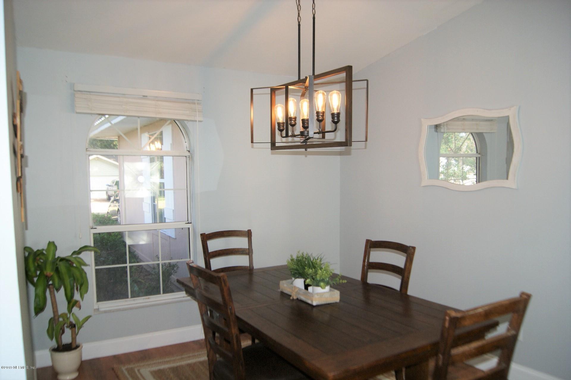 510 Jasmine Road St. Augustine, FL 32086 - Photo 4 of 14 a view of a dining room with furniture and chandelier