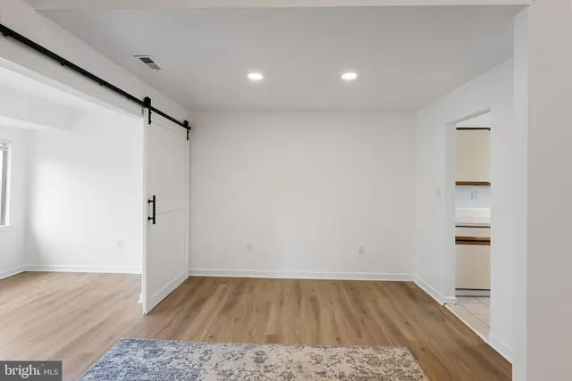 a living room with a fireplace and wooden floor