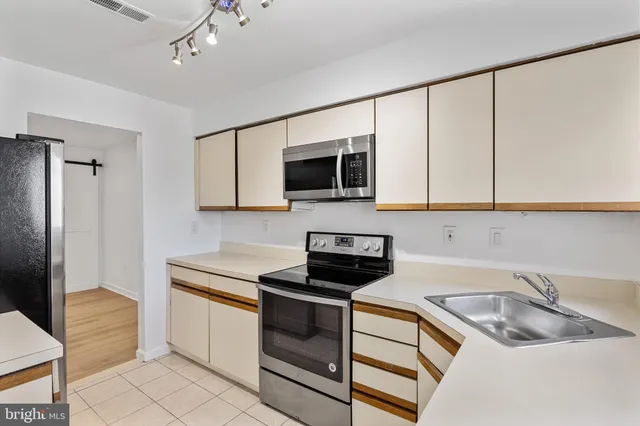 a kitchen with stainless steel appliances a refrigerator and a sink