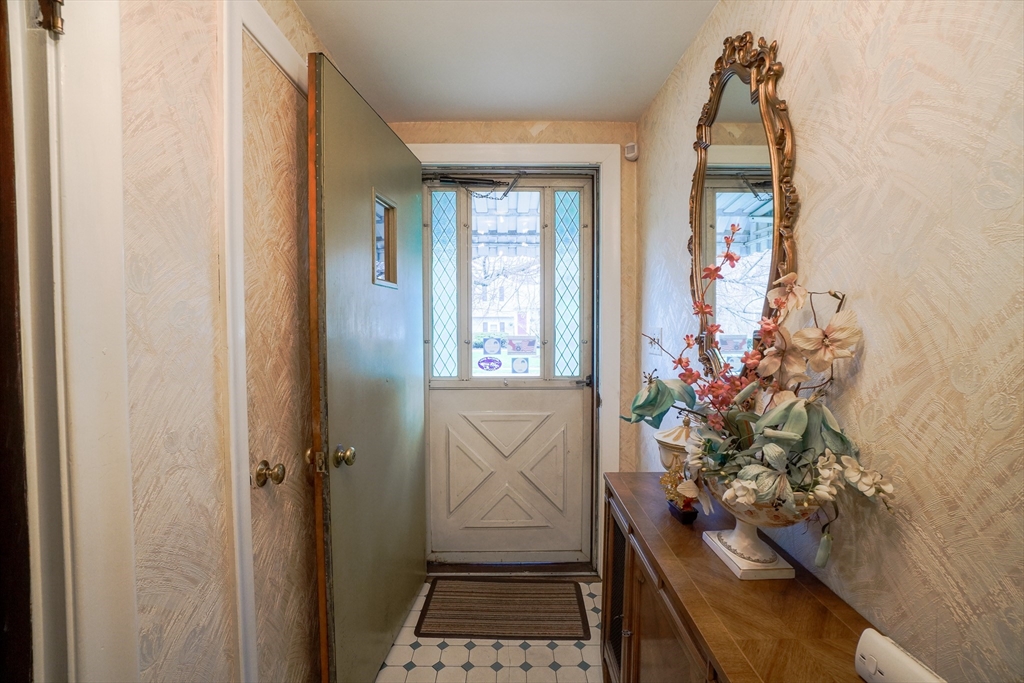 53 Yale Road Needham, MA 02494 - Photo 6 of 21 a room with painting on the wall and a potted plant