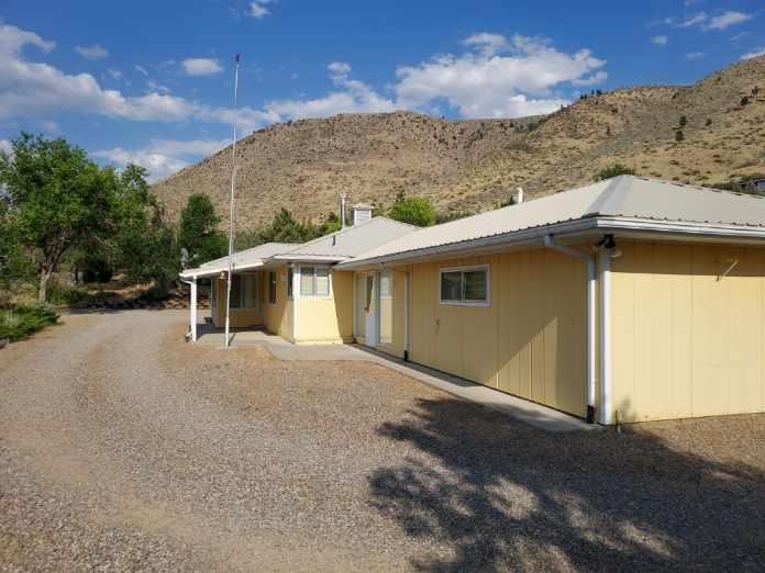 59 Dry Canyon Road Coleville, CA 96107 - Photo 2 of 17 Rear view of property with a mountain view and a metal roof