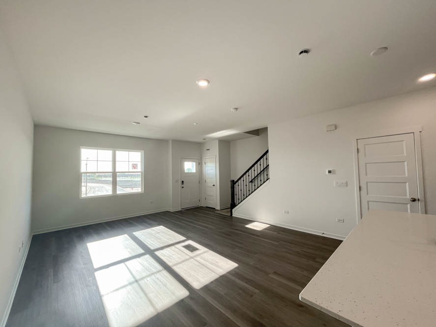 2239 Riesling Road Oswego, IL 60543 - Photo 5 of 49 a view of empty room with wooden floor and fan