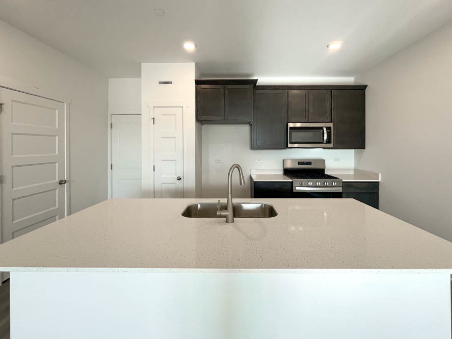 2239 Riesling Road Oswego, IL 60543 - Photo 6 of 49 a kitchen with stainless steel appliances kitchen island granite countertop a sink and cabinets